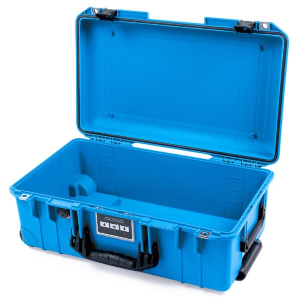 Open electric blue ColorCase Pelican Air 1535 carry-on case with black handles and latches. The empty interior is smooth and solid, featuring a rectangular shape. A label with dials is visible on the front side of this medium-size waterproof case.